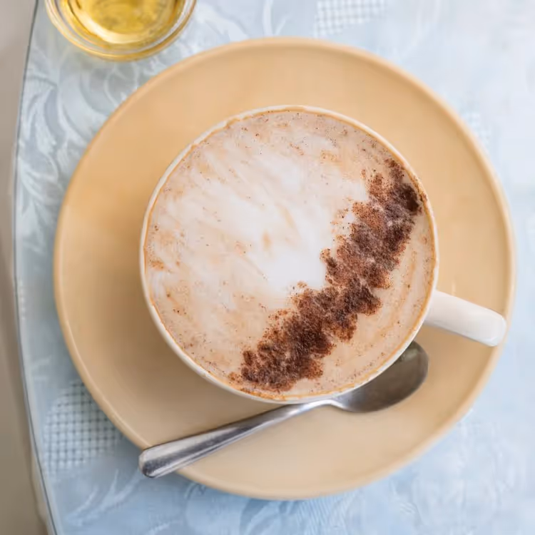 A cup of coffee with chocolate sprinkles