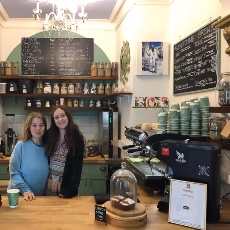Two ladies behind the counter in a cafe