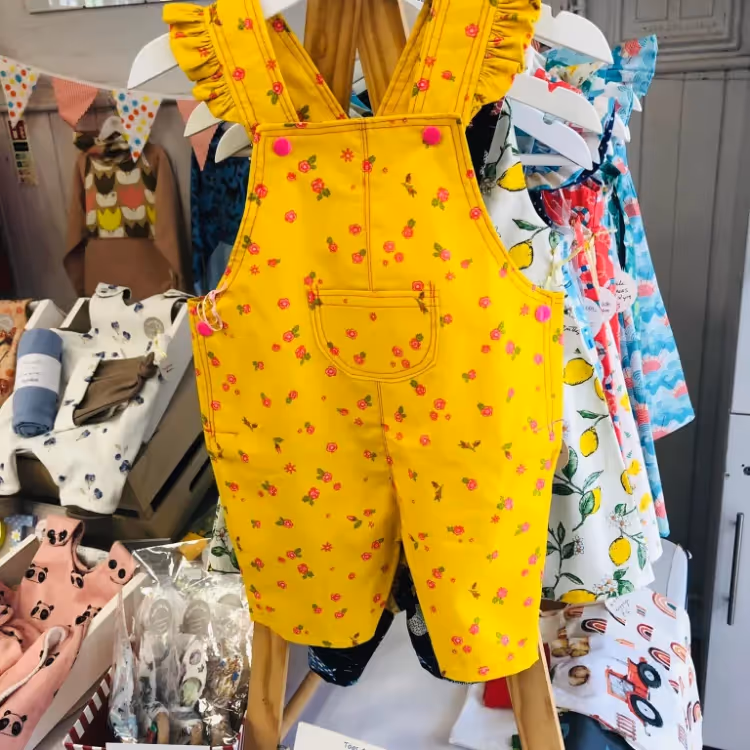 A bright yellow romper suit