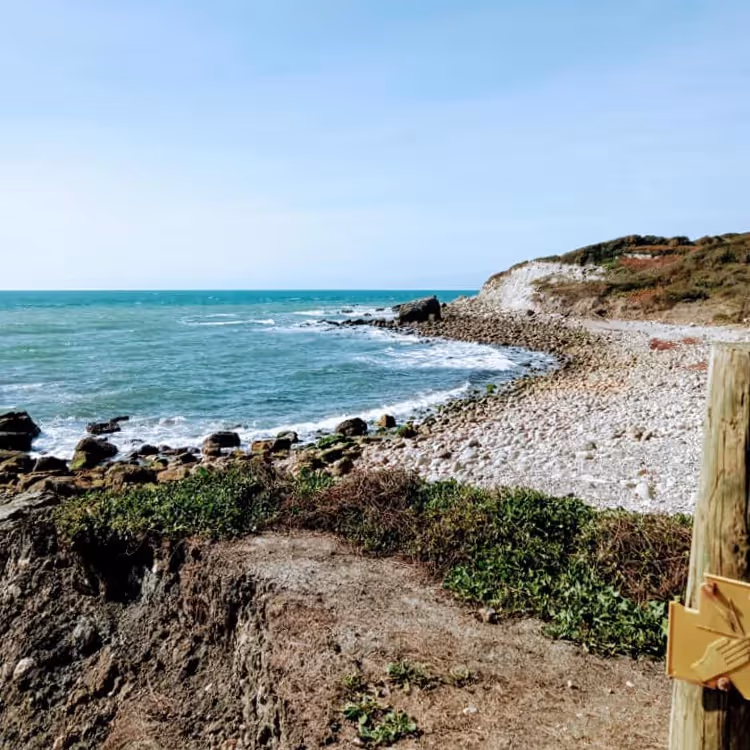 A remote beach with shingle and rocks