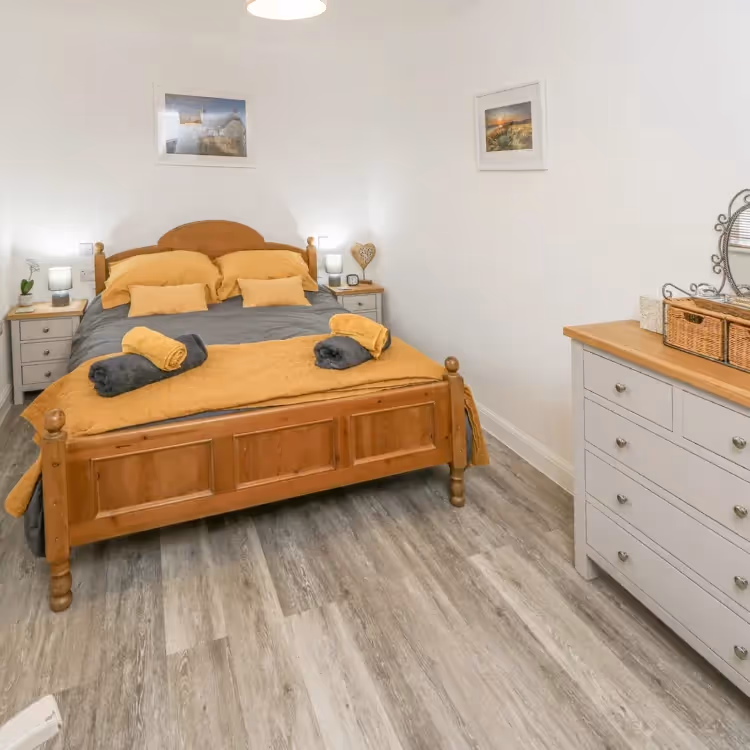 A modern bedroom with pine furniture