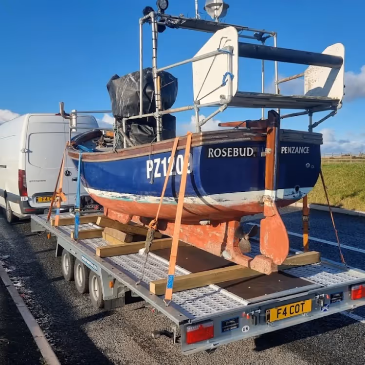 A boat being transported on a low loader