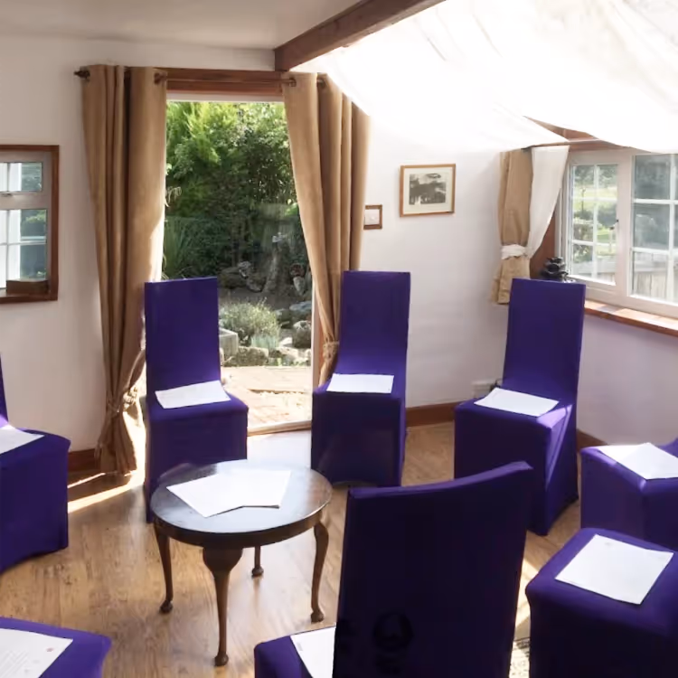 A residential room set up for a business meeting
