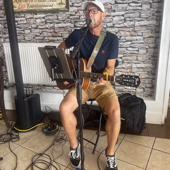 A man playing acoustic guitar