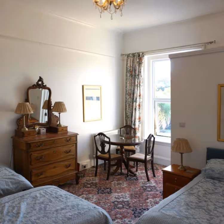 A large traditional bedroom with 3 beds