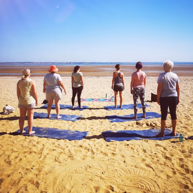 A pilates class on the beach