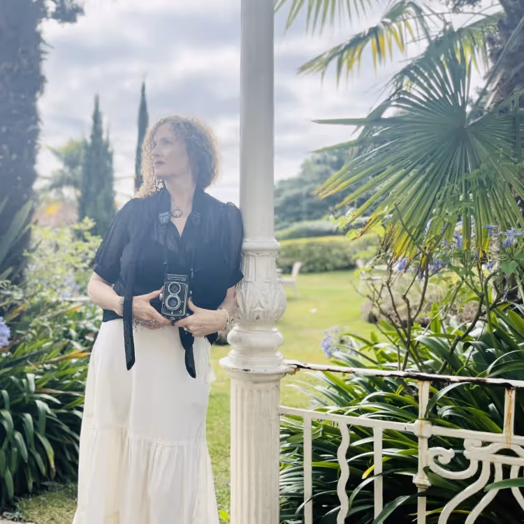 A photographer with a antique twin lens reflex camera