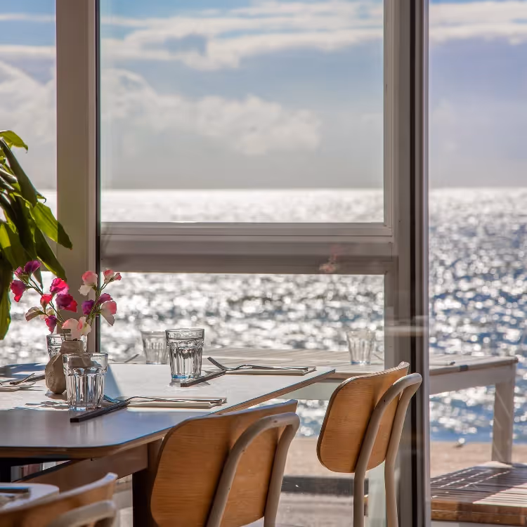 Looking through the windows of a restaurant out to sea