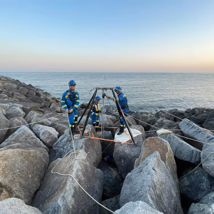 Coastguard rescue team on rocks