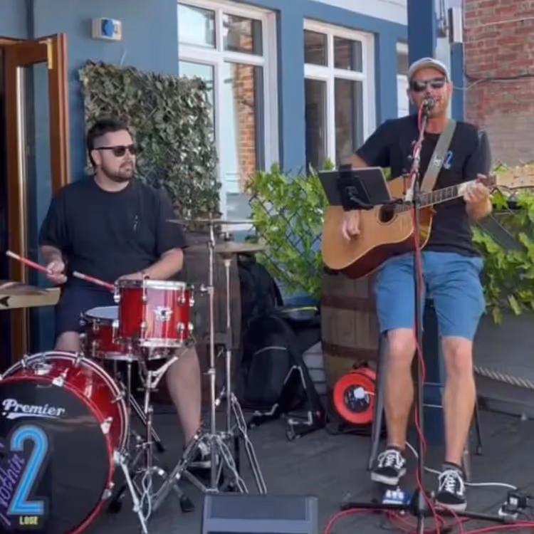 Two musicians playing outdoors