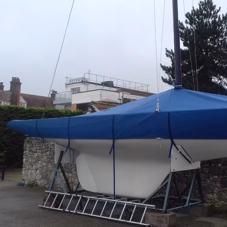 A blue canvas cover on a white yacht