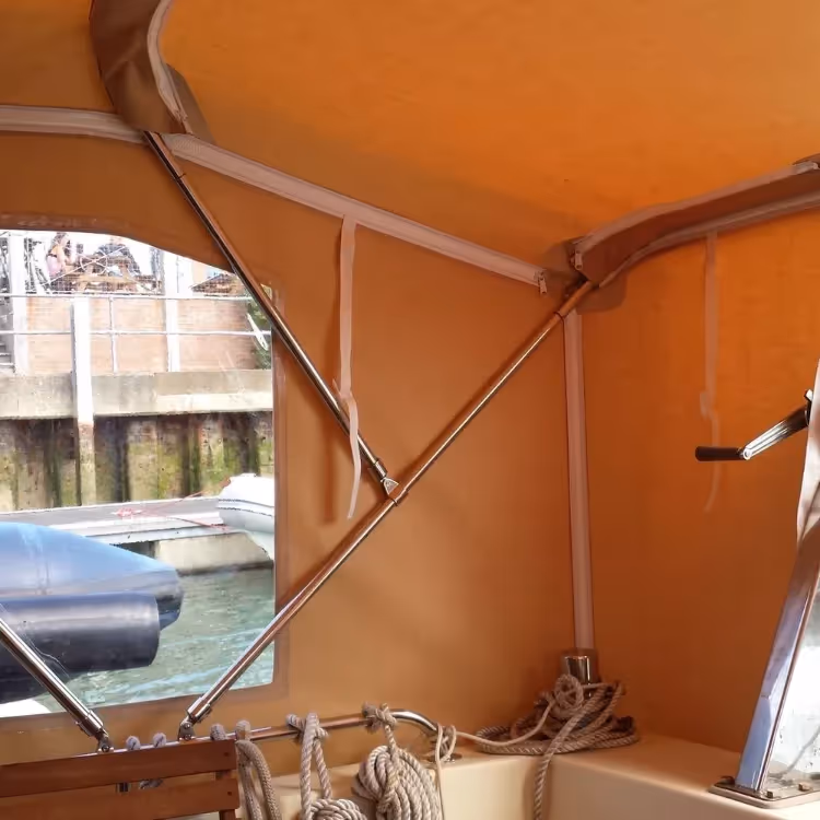 A beige custom made canopy on a boat