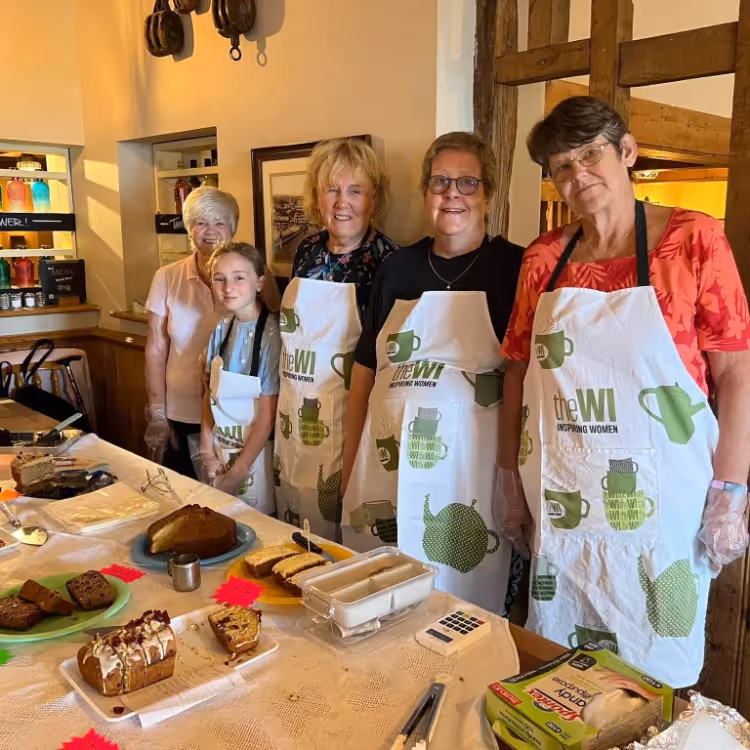 Four ladies at a cake stall