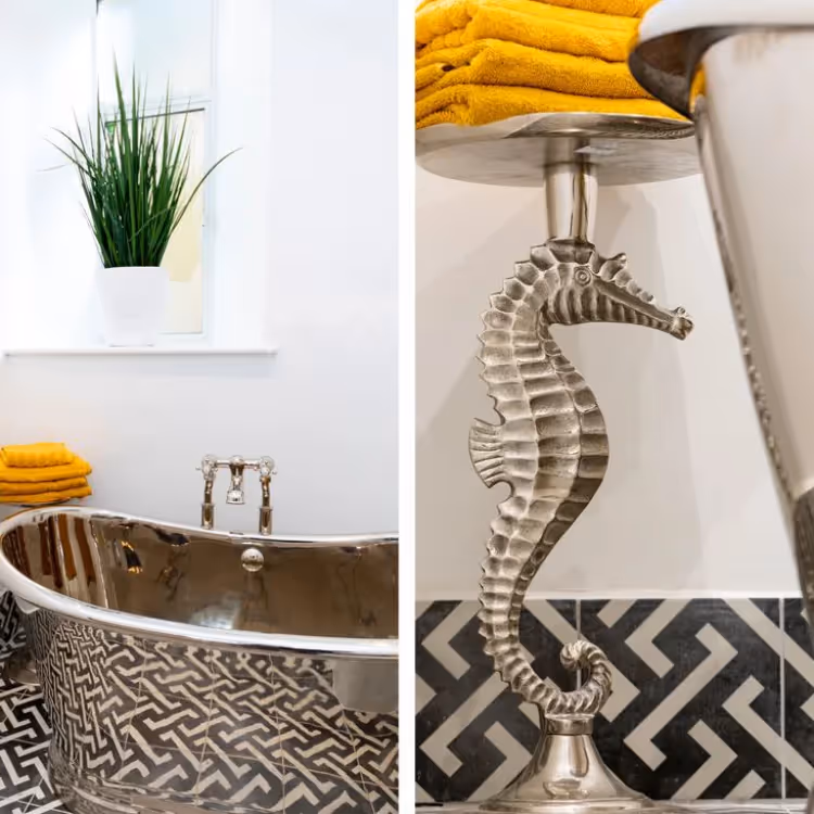 A black and white bathroom with a freestanding tin bath