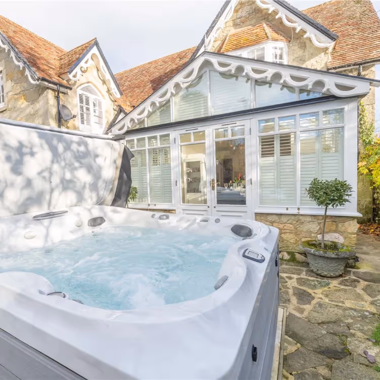 A hot tub outside a period property