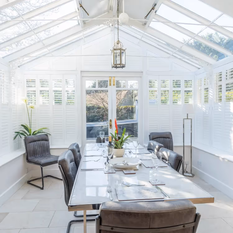 A large conservatory used as a dining room