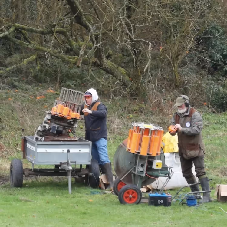 Men setting up traps for a clay pigeon shoot