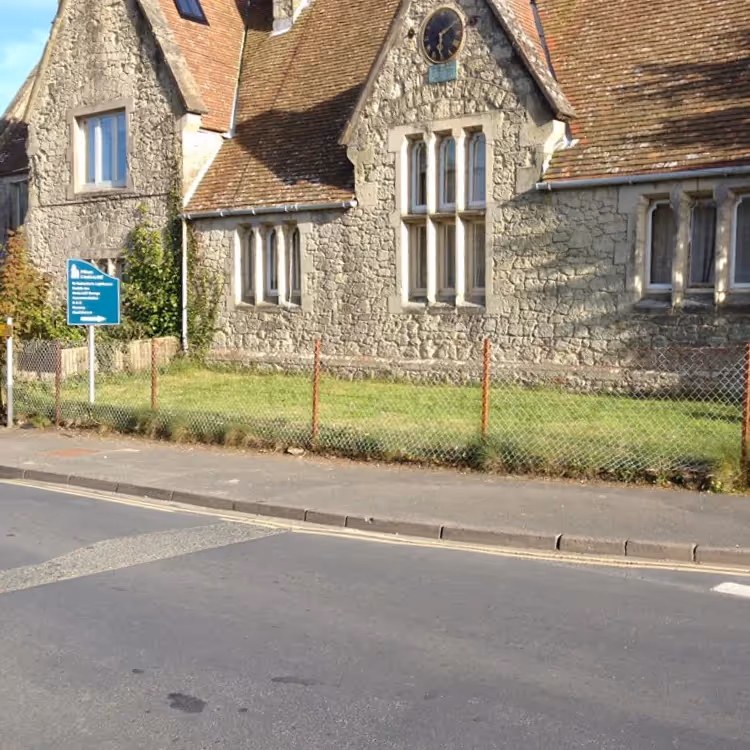 The exterior of a stone Victorian school house