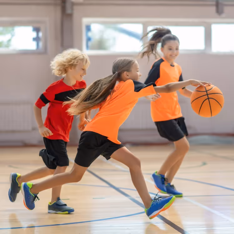 Three kids playing basketball