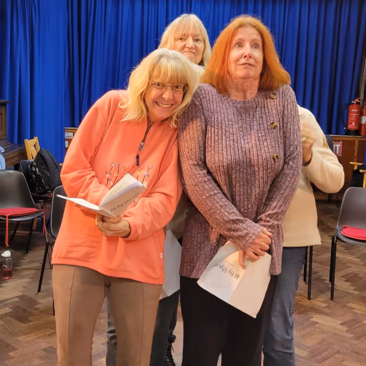 Three lady performers at a theatre rehearsal