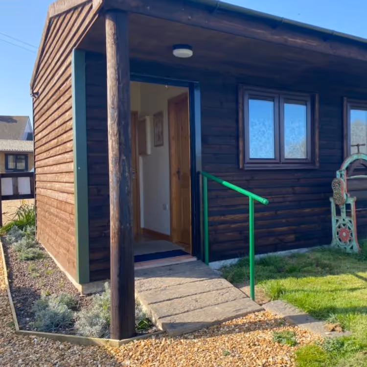 A wooden clad building with wheelchair friendly access