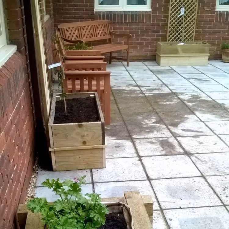 A courtyard with wooden troughs and benches