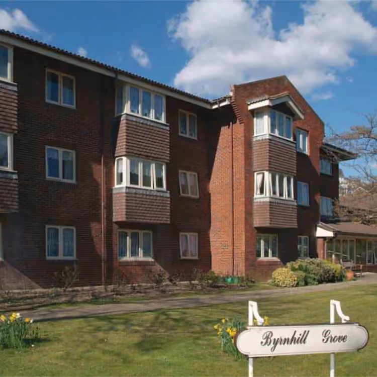 The exterior of a red brick and tiled care home