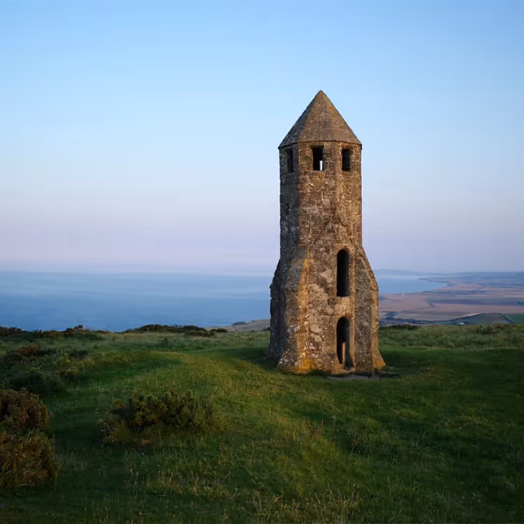 A medieval lighthouse on a hill