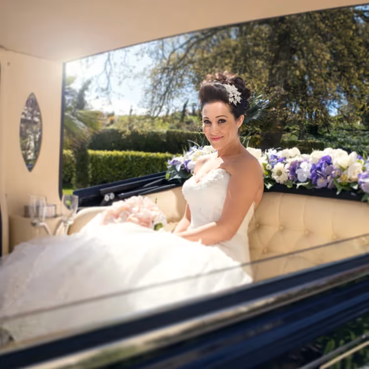 A bride in a vintage wedding car