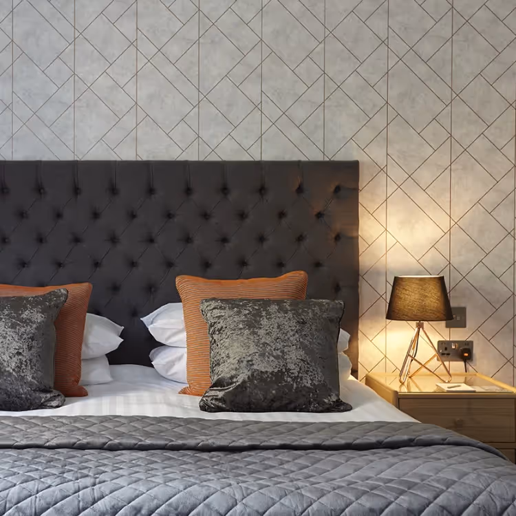 An elegant bedroom decorated in taupe grey and burnt orange