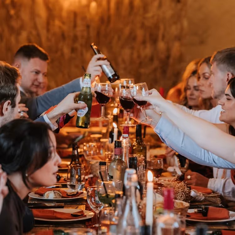 Wedding guests raising a glass of champagne to the bride and groom