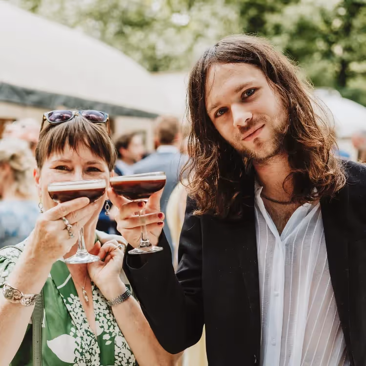 A couple enjoying espresso martinis at a wedding party