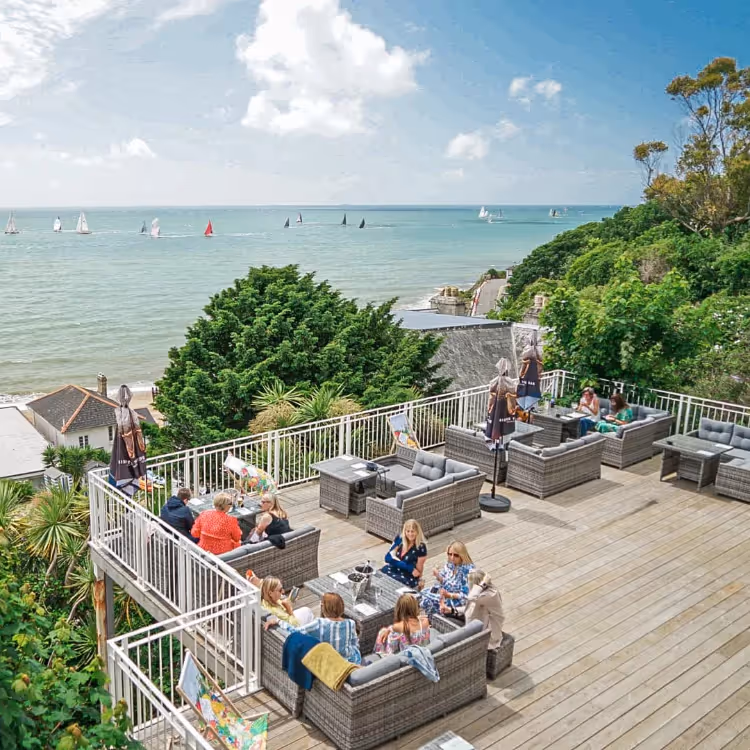 A terraced Hotel dining deck overlooking the sea