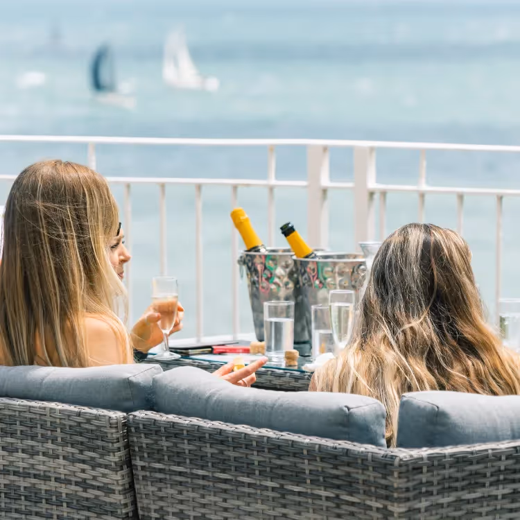 Ladies enjoying champagne whilst watching a yacht race