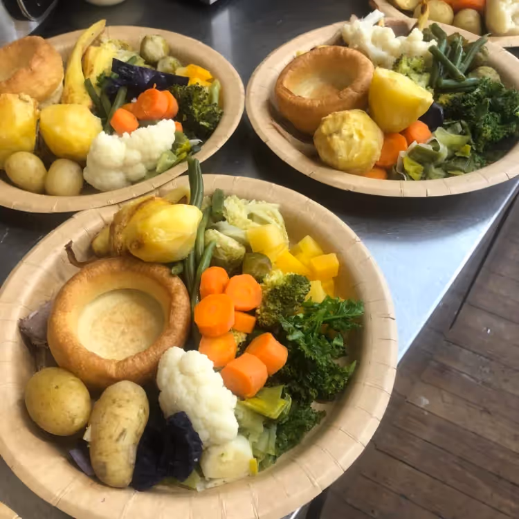 Three roast dinners on plates