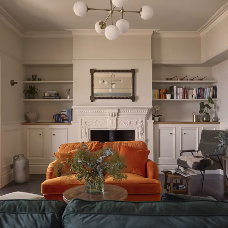 A classic living room with teal and burnt orange sofas
