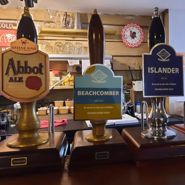 A bar with three ale pumps