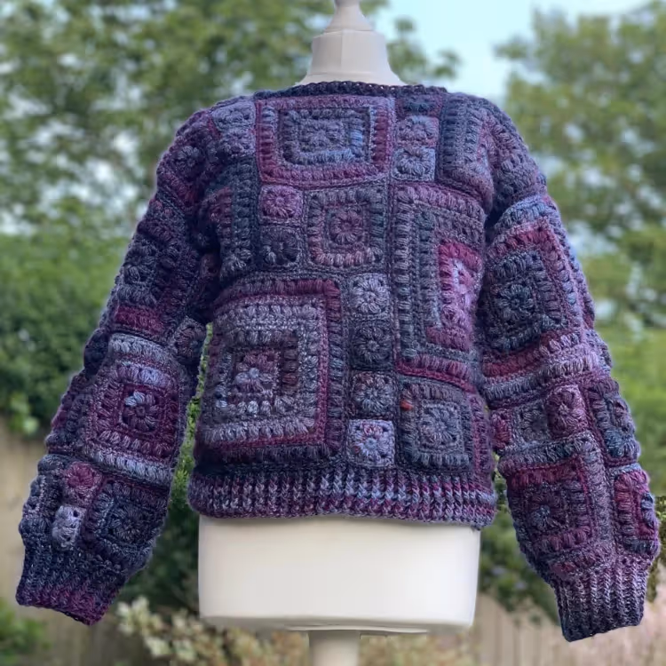 A crocheted jacket in purple and lilac