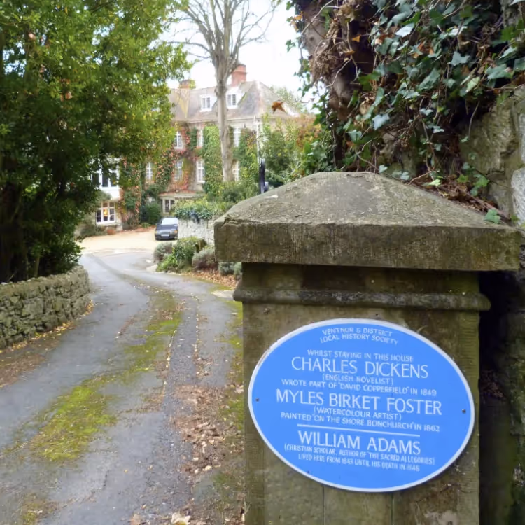A stone pillar at the entrance to a country house