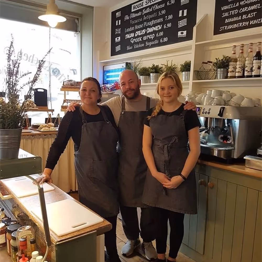 Three members of staff in a kitchen takeaway