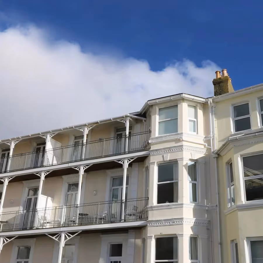 The exterior of a victorian apartment building with balconies