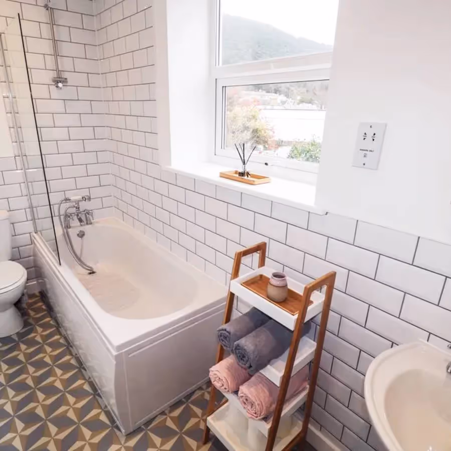 A bathroom with a grey patterned tiled floor