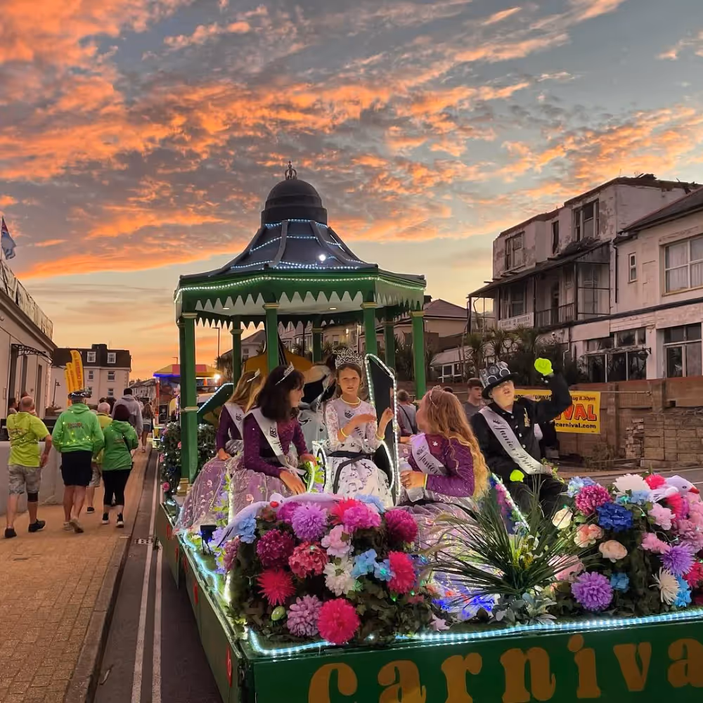A carnival float under a beautiful sunset