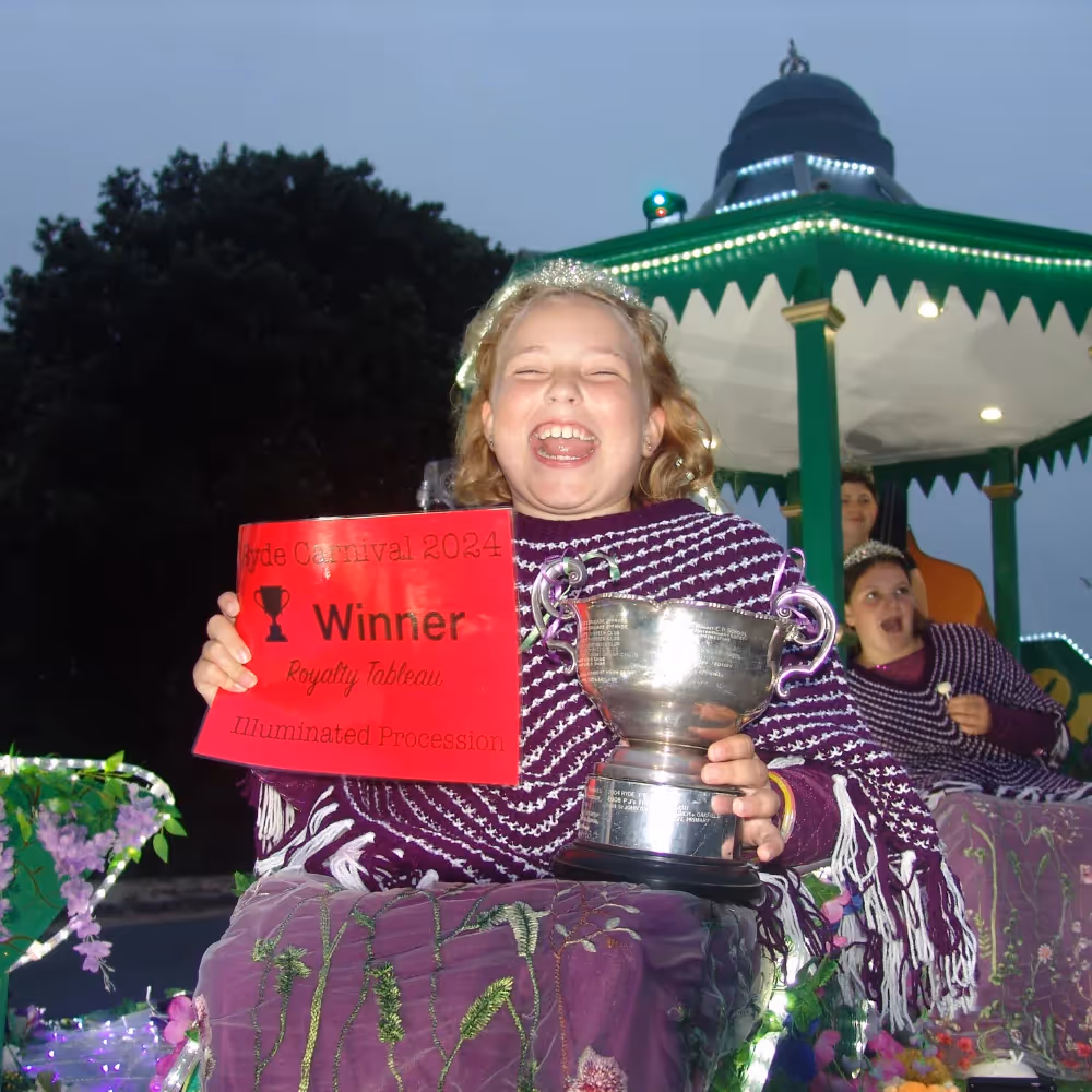 A carnival queen winner holding up her certificate