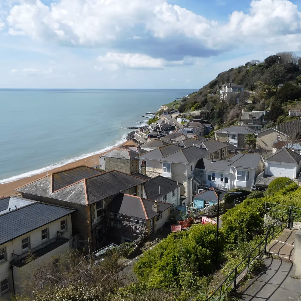 An elevated view looking down to a town and a bay