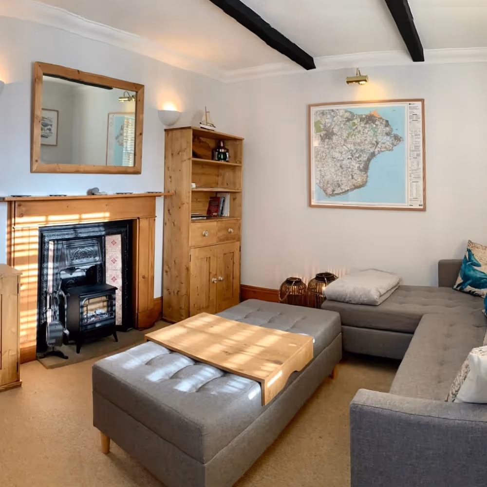 A cosy living room with pine furniture and grey upholstery