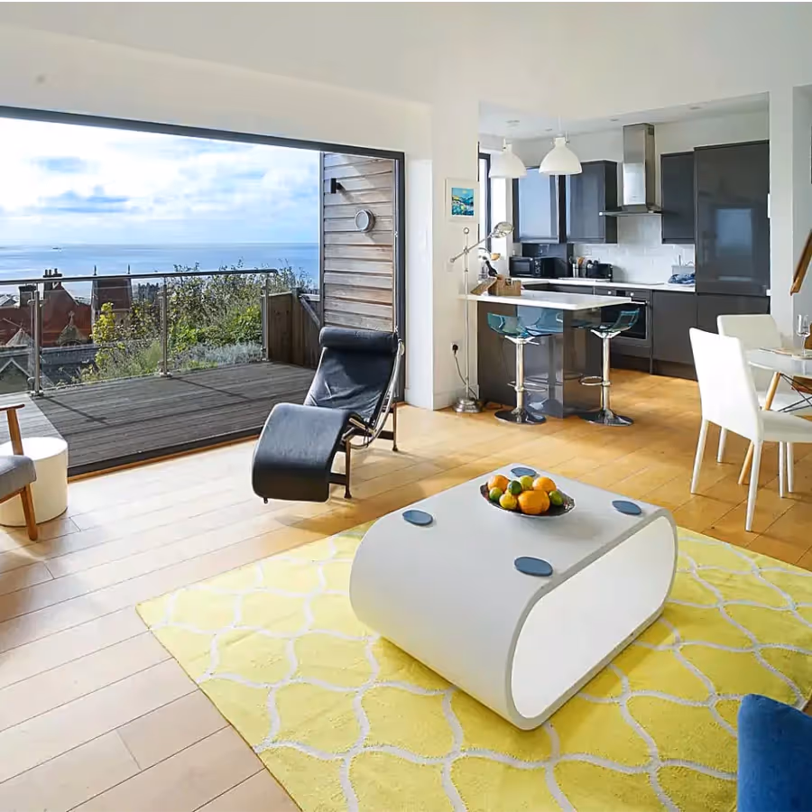 A modern open plan living space overlooking the sea