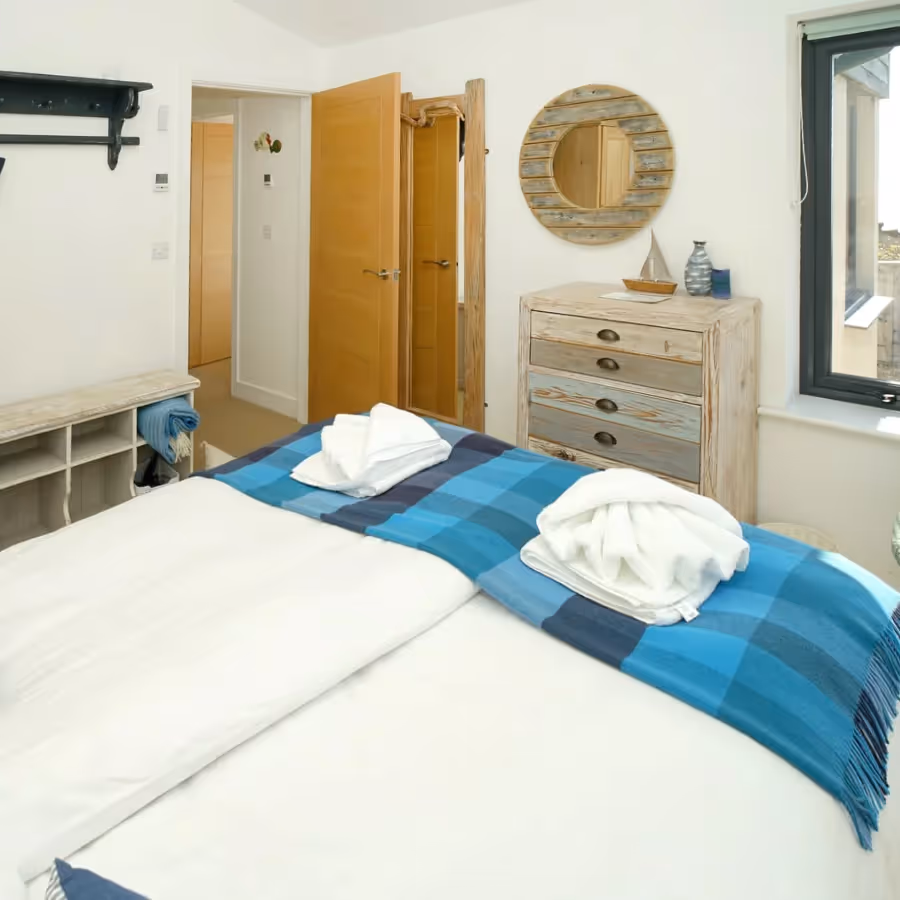 A bedroom with a blue and white nautical theme