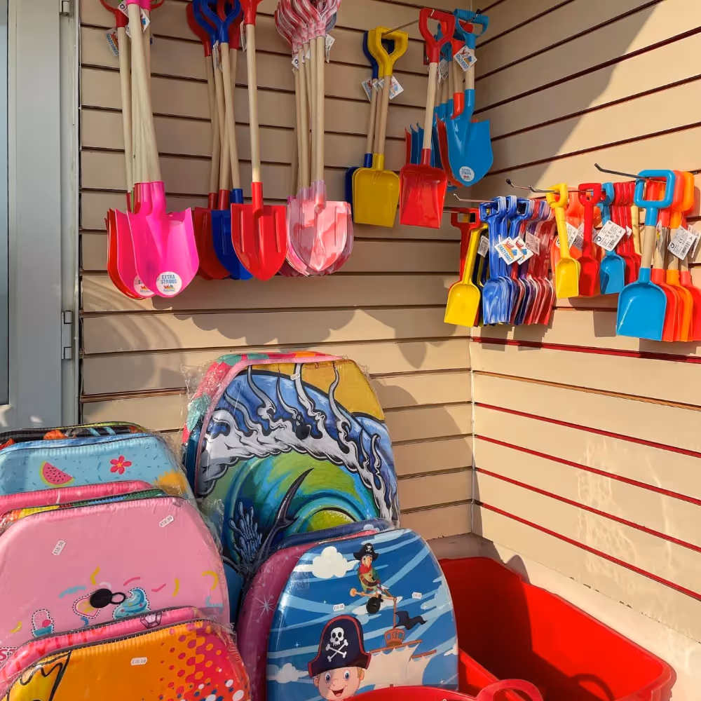Buckets, spades and bodyboards in a beach shop