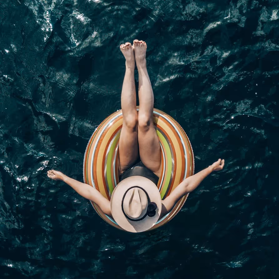 A lady floating on a rubber ring in the sea